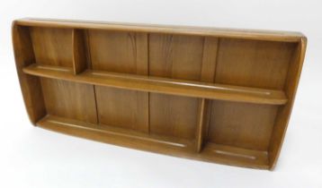 An Ercol blond elm sectional wall shelf, having panelled back and routed plate holders, 49.5 x 106.