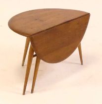 A 1960s Ercol blond elm low single drop flap occasional table, having gate-leg action, on turned