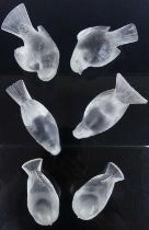 A collection of six Lalique moulded and frosted glass bird ornamental paperweights, in varying