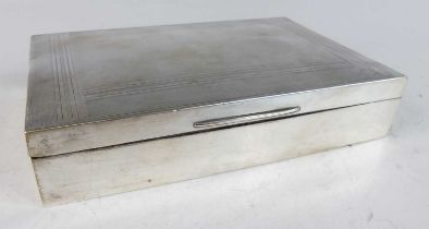 A late Art Deco silver table cigarette box, the hinged engine turned cover enclosing cedar lined