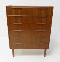 A 1960s Danish teak chest of six long drawers, the upper drawer with locking mechanism (with key),