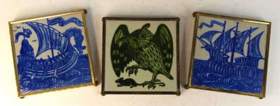 A set of three earthenware tiles in the style of William De Morgan, two being blue and white and the