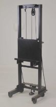 A contemporary black painted iron artists easel, with rise-and-fall action, as converted from a sack