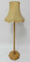 An Art Deco birch standard lamp, having hexagonal tapering column to lower acanthus leaf carved