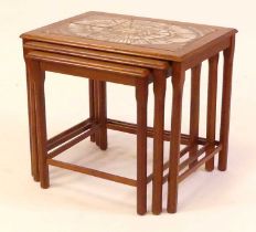 A 1970s Toften Möbelfabrikken teak and tile top inset nest of three occasional tables, raised on