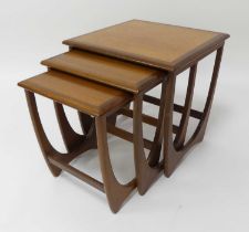 An 1960s G-Plan 'Fresco' teak nest of three occasional tables, raised on curved end supports