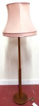 A 1960s probably G-Plan teak standard lamp, with turned colum to grid lower detail, on circular