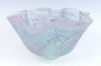 Peter Layton (b.1937) - an iridescent studio glass handkerchief footed table bowl, of typical shaped