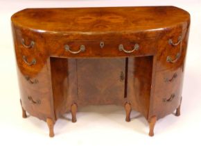 An Art Deco figured walnut kneehole desk by Maurice Adams Ltd, of kidney form with central frieze