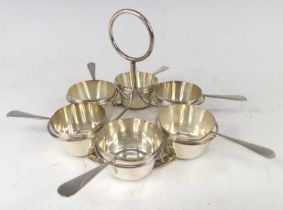 An early 20th century silver six place condiment set, housed on wired silver holder with loop