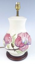 A contemporary Moorcroft Magnolia pattern pottery table lamp, of lower bulbous form, underglaze
