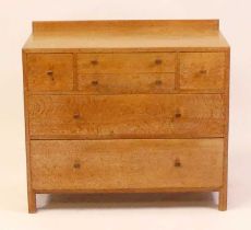 A Heal's 1930s limed oak ledge back chest, having an arrangement of four short upper drawers over