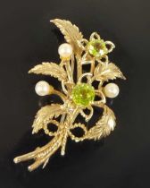 A 9ct yellow gold, peridot and pearl floral spray brooch, featuring a 5.2mm and 6.1mm round