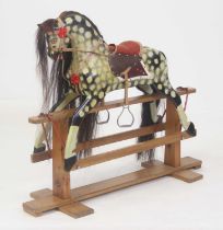 An early 20th century child's dapple-grey rocking horse, probably by Collinson, with tack, mane