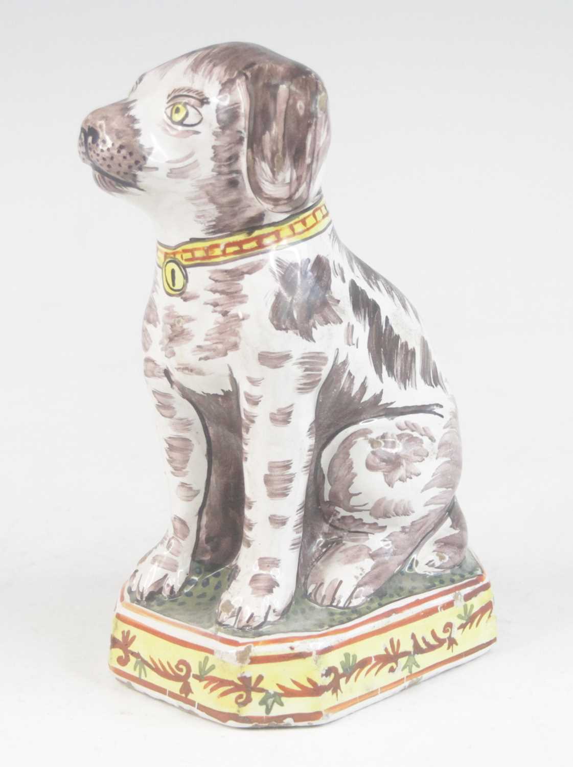 A Delft or Faience polychrome model of a dog, shown seated upon a canted plinth, PAK monogram to the - Image 2 of 5