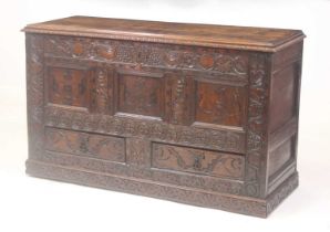 An antique oak mule chest, circa 1700 and later, the two-plank top on replacement iron strap hinges,