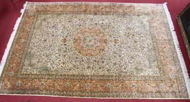 An Indian fineweave silk Tabriz carpet, having a central beige field with medallion issuing