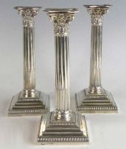 A set of three Victorian silver candlesticks, of Corinthian form with stop fluted columns and