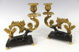 A pair of Regency bronze and gilt bronze candelsticks, each of heavy scroll acanthus leaf form and