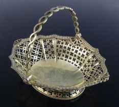 A late 18th century silver-gilt swing handle bonbon basket, of shaped oval form to a flared