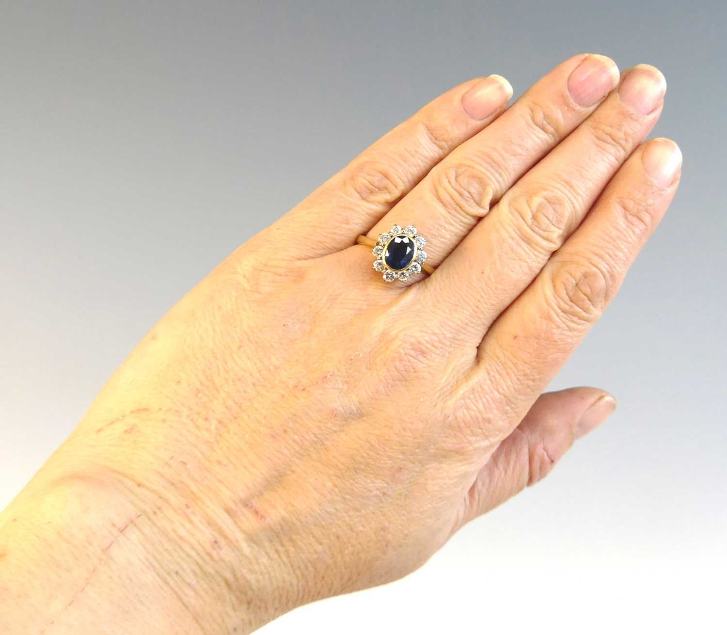 An 18ct yellow and white gold sapphire and diamond oval cluster ring comprising a centre sapphire - Image 8 of 8