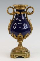 A French blue porcelain and gilt metal mounted urn, 19th century, of baluster form, flanked by