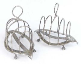 A pair of late Victorian silver toast racks, each of elongated oval form with rounded arched