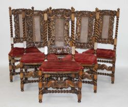 A set of eight walnut dining chairs in the Caroleon style, each having cherub and crown carved top