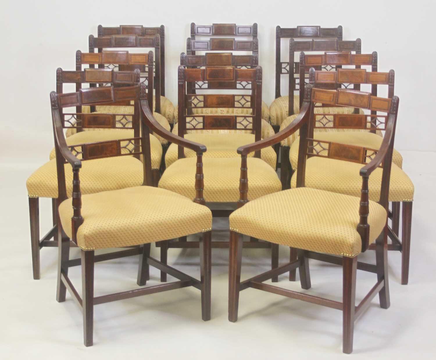 A set of eight late Georgian mahogany barback dining chairs, each having reeded and acanthus leaf