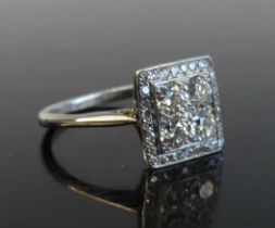 A white metal diamond square cluster ring featuring a centre quatrefoil of old European cut diamonds