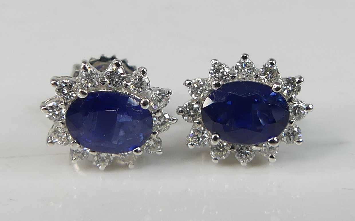 A pair of white metal sapphire and diamond oval cluster earrings, each comprising an oval sapphire - Image 2 of 4