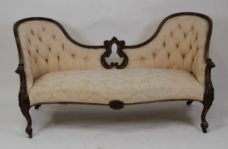 A Victorian rosewood framed double spoonback settee, the swept frame being re-upholstered in a