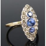 A yellow and white metal, sapphire and diamond navette style cluster ring, featuring three graduated