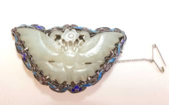 An Art Noveau style white metal butterfly brooch with carved jadeite centre and enamel border with