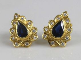 A pair of yellow metal sapphire and diamond leaf shaped cluster earrings, each with a centre pear