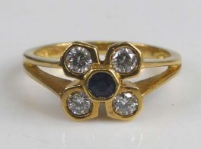 An 18ct yellow gold sapphire and diamond flower head cluster ring, featuring a centre round sapphire
