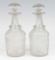 A pair of glass decanters, early 19th century, each of mallet form, etched with a stagecoach and