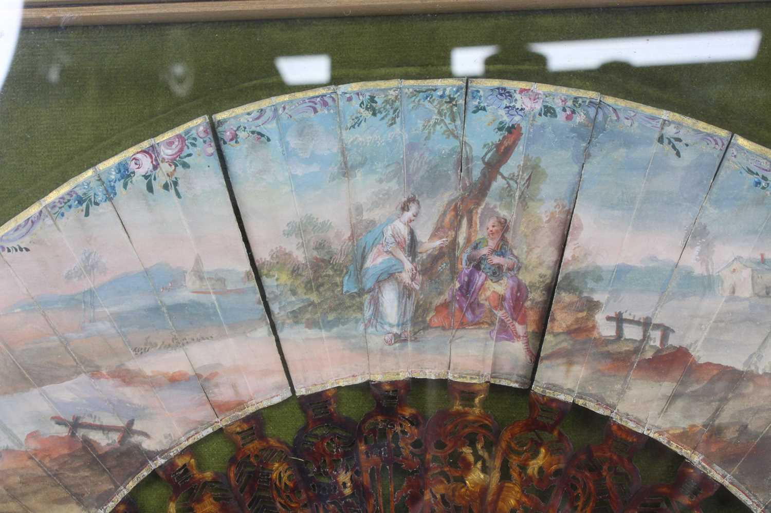 A late 19th century tortoiseshell and painted fan, the sticks each with pierced carving, the fan - Image 2 of 3