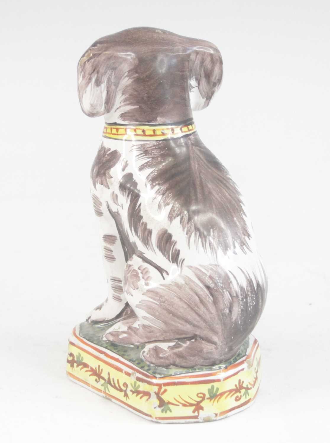 A Delft or Faience polychrome model of a dog, shown seated upon a canted plinth, PAK monogram to the - Image 3 of 5