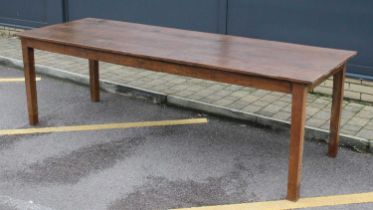 An antique elm refectory table, having a four plank top, the joined base with plain frieze, raised