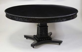 An ebonised hardwood pedestal breakfast in the Regency taste, of good size, the circular fixed top