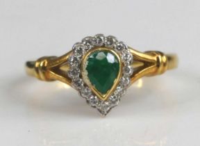 An 18ct yellow and white gold, emerald and diamond pear shaped cluster ring, having a pear cut