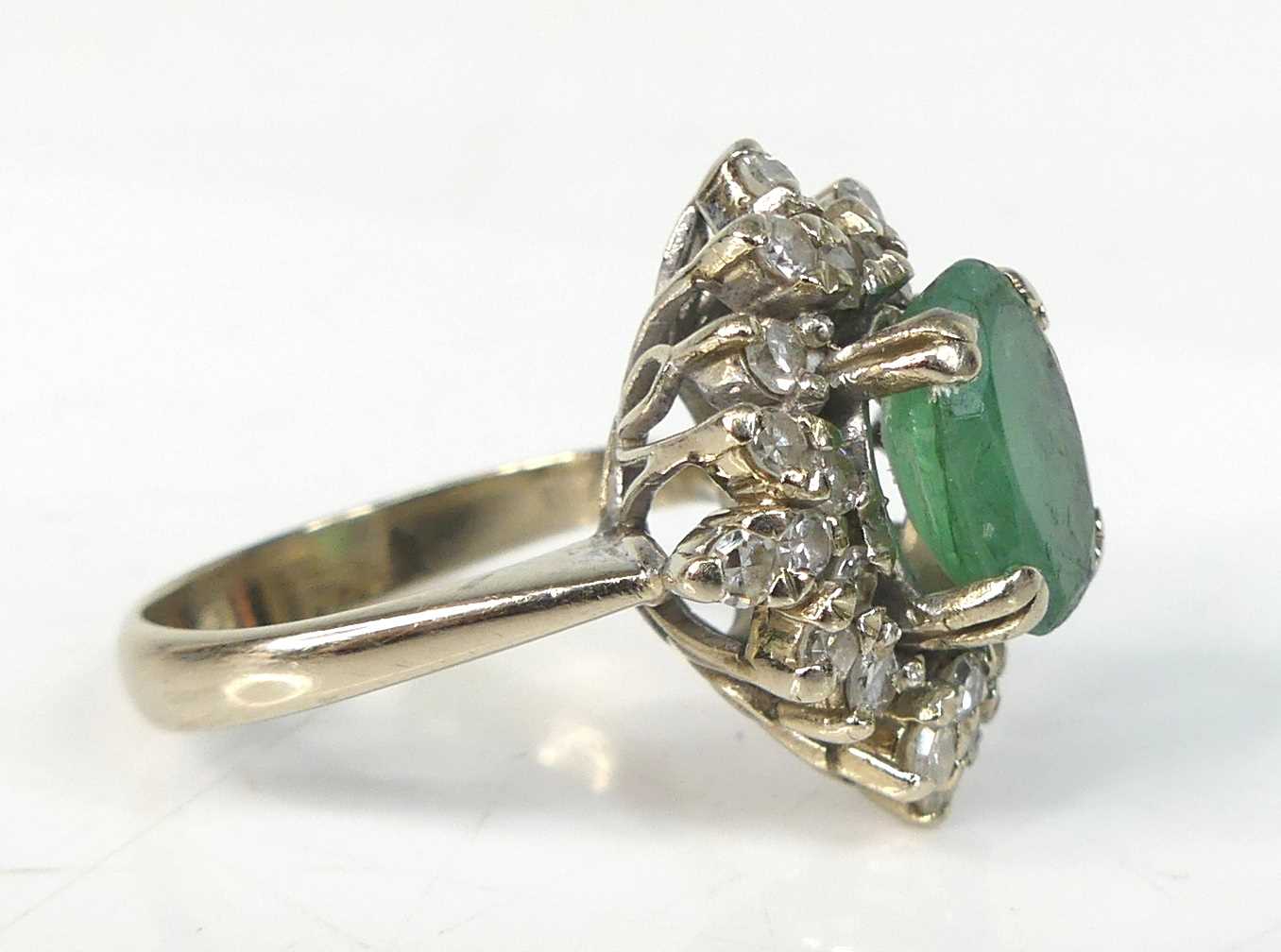 A white metal, emerald and diamond oval cluster ring, comprising a centre oval emerald within a - Image 2 of 7