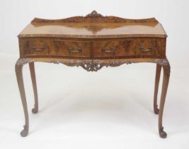 A walnut and figured walnut canteen table, mid-20th century, of serpentine outline, having fitted