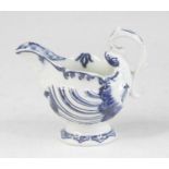 A Derby blue and white porcelain dolphin cream boat, circa 1770, of shell moulded form, h.8cm