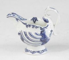 A Derby blue and white porcelain dolphin cream boat, circa 1770, of shell moulded form, h.8cm