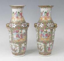 A pair of Chinese Canton porcelain vases, 19th century, each flanked by gilt lion mask handles,