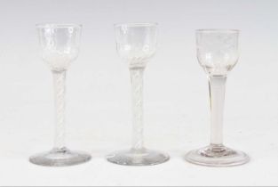 A pair of wine glasses, circa 1770, the basal fluted ogee bowls above a multi series opaque twist