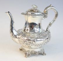 A Victorian silver teapot, of squat baluster form to a pedestal four-footed base, having chased