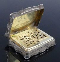 An early Victorian silver vinaigrette, of shaped rectangular form, having tartan effect bright cut